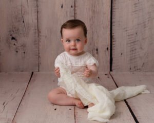 Baby girl sitting for a photo in Sharon Lewis Photography's Bridgwater Somerset