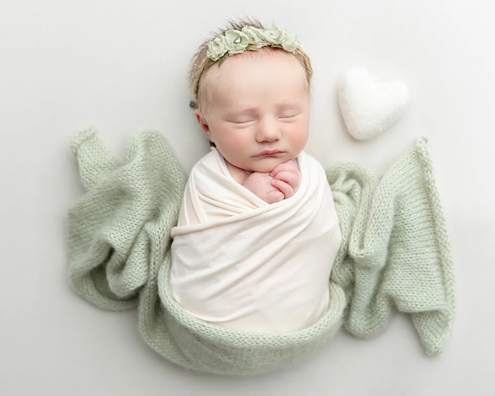 Newborn girl swaddled in photo session in Somerset studio
