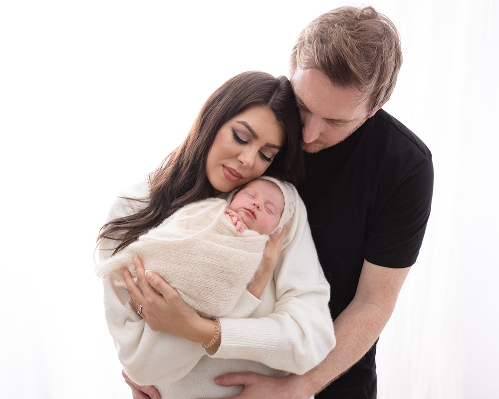 newborn with mum and dad during newborn photo session