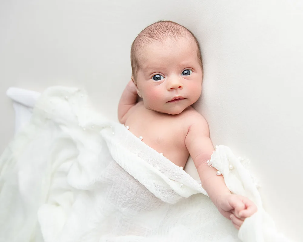 baby photos in Bridgwater by Sharon Lewis Photography Baby looking at camera during newborn mini session