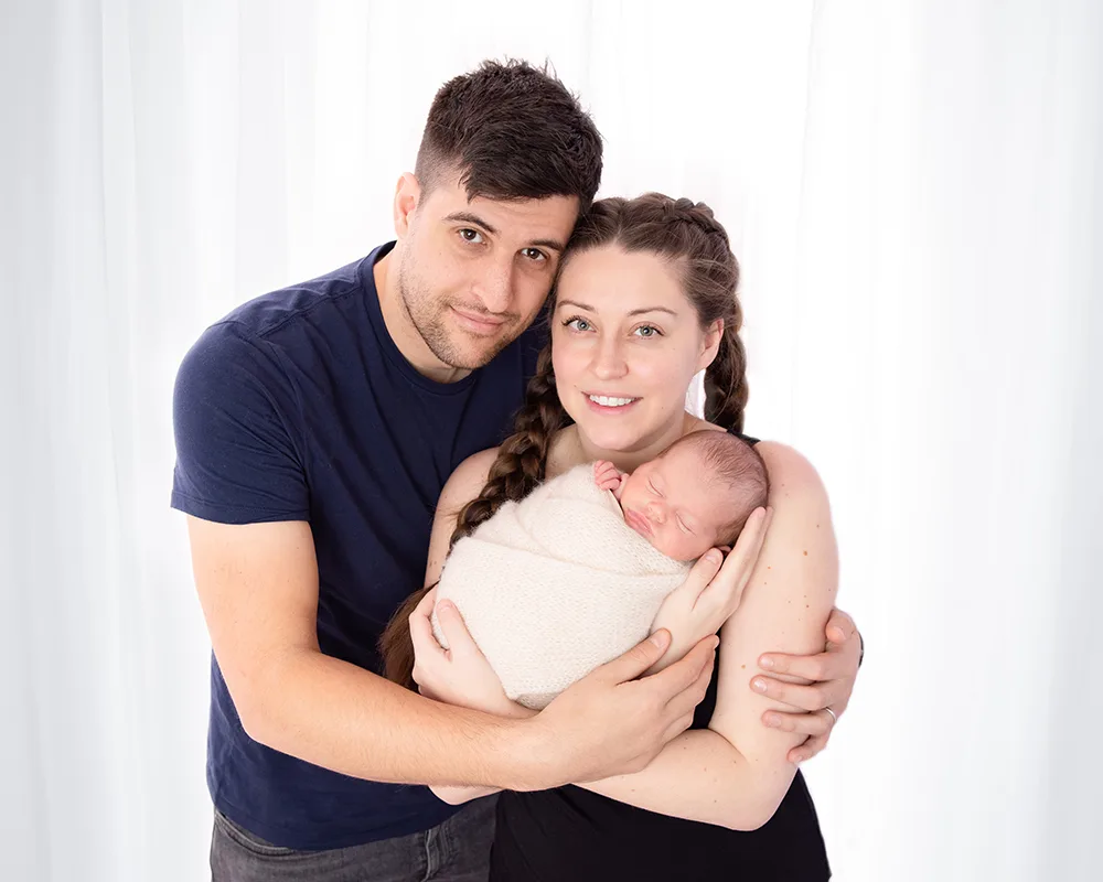 mum and dad with newborn in arms